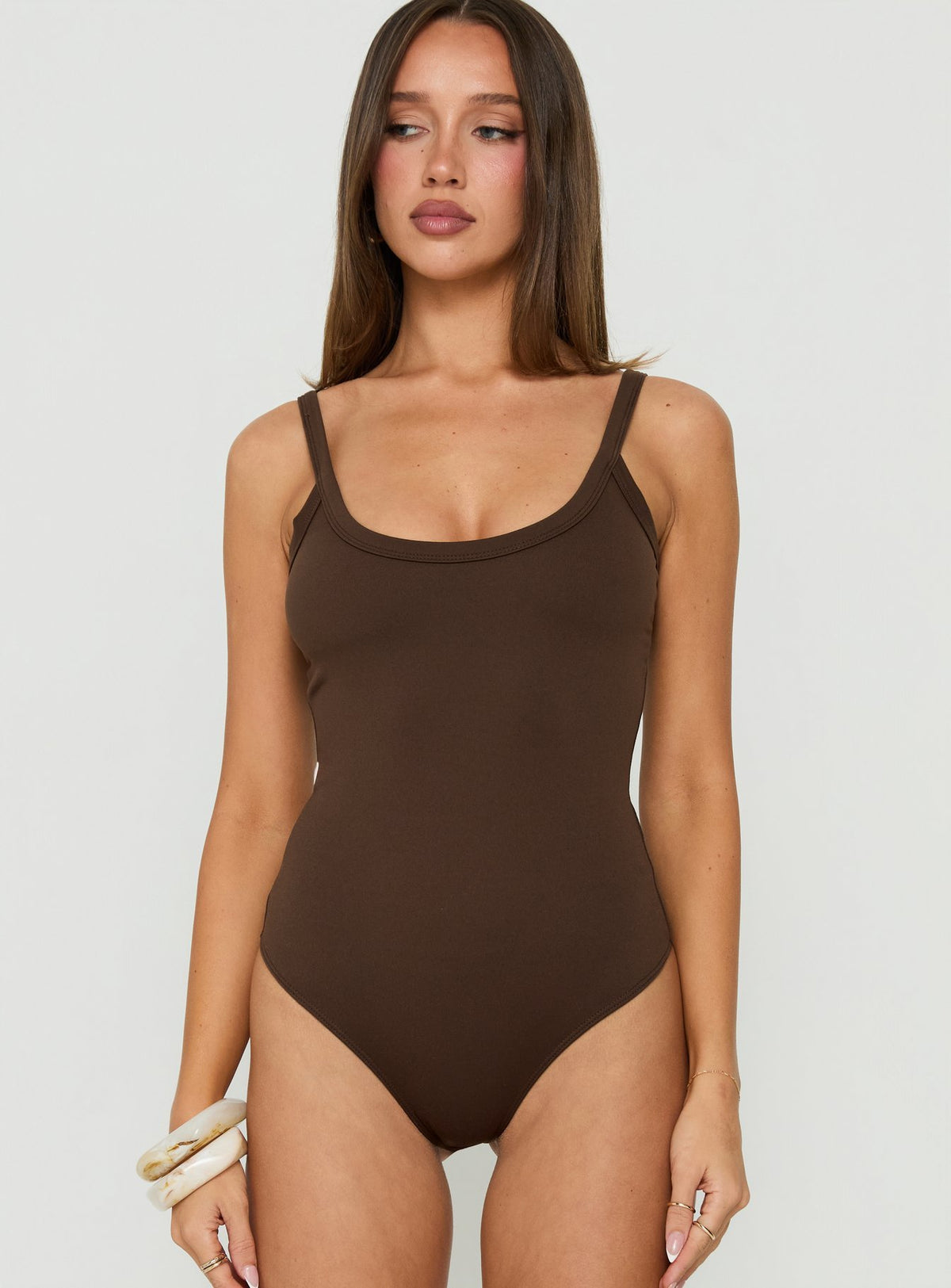 Showcasing the Daily Define Kasper Bodysuit Brown womens-bodysuit with sleeveless design front view of model wearing Princess Polly