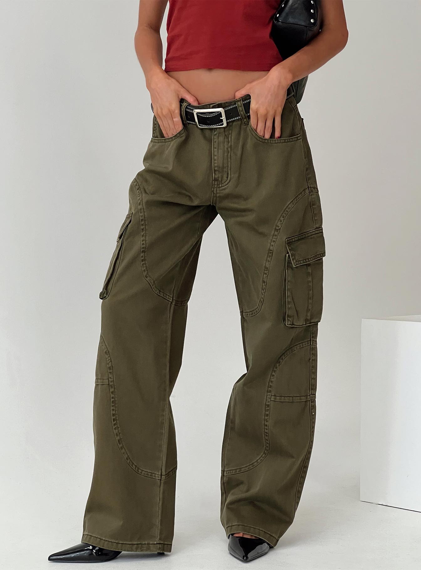 side view of model wearing Princess Polly Ahstin Cargo Jeans Green Low Rise Jeans 