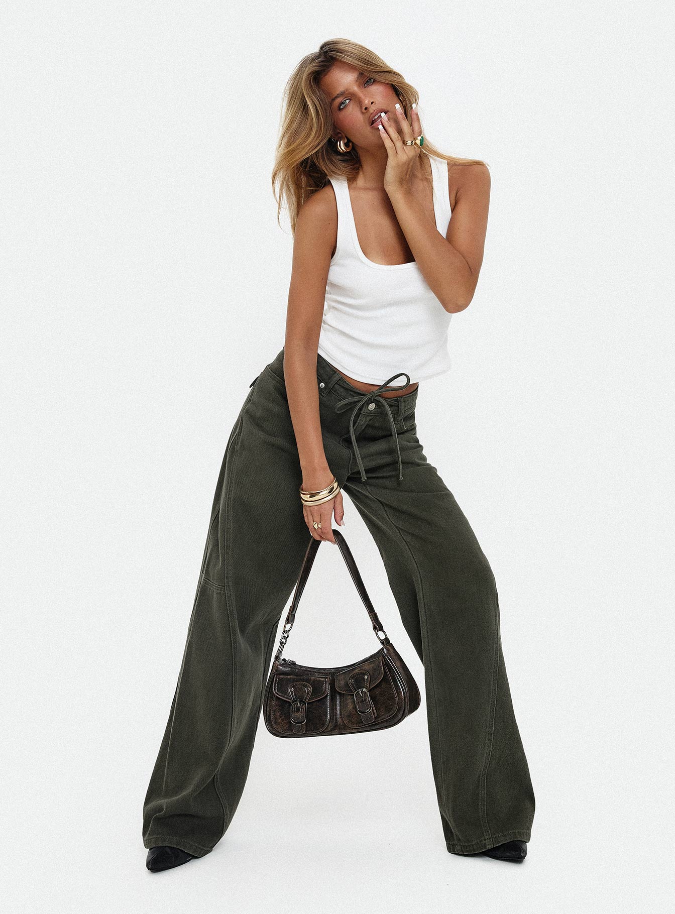 front view of model wearing Princess Polly Bruiser Tie Waist Mid Rise Wide Leg Jeans Green Petite High Rise Jeans 
