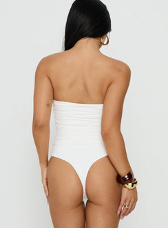 Designed with sleeveless silhouette, the See Me Soon Strapless Hardware Detail Bodysuit White back view of model wearing Princess Polly