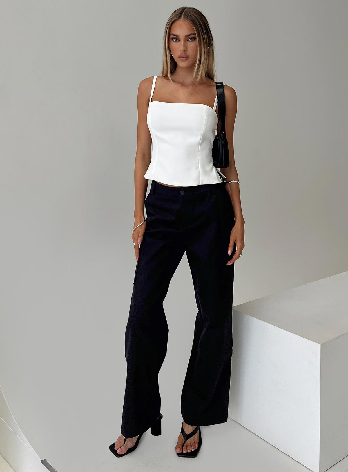 front view of model wearing Princess Polly Raider Low Waist Cargo Pant Black High Waisted Pants 