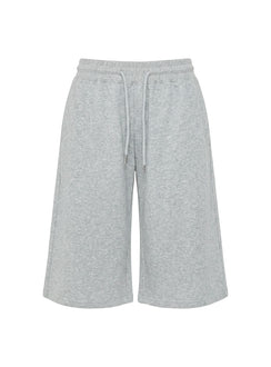 Highlighting the drawstring detail of the Nikko Longline Fleece Shorts Grey Marle in womens regular pants with mid-rise Princess Polly