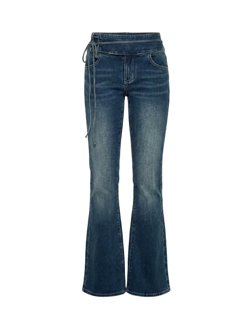 Crafted from Runa Low Rise Tie Side Jeans Mid Blue Wash featuring womens-jeans with flared wide-leg silhouette Princess Polly