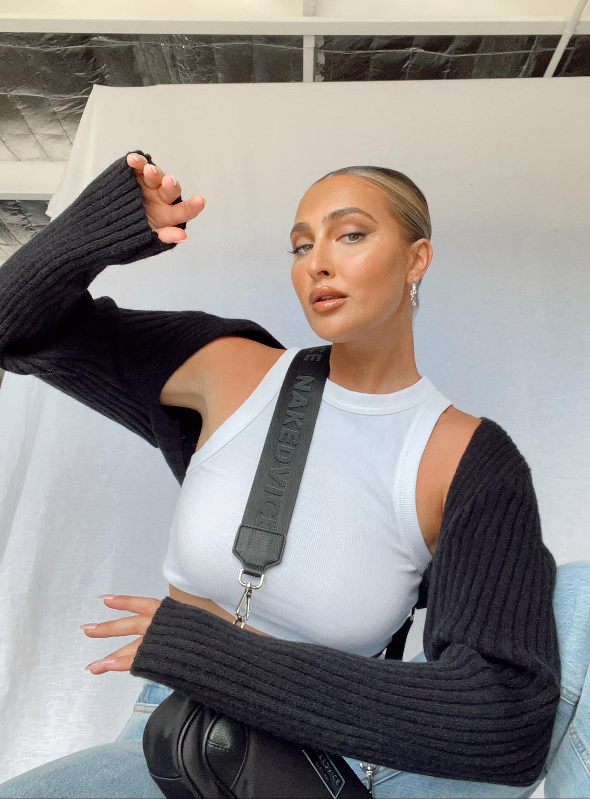Showcasing the Aytan Bolero Sweater in Black, a short womens jumper featuring cold shoulder design, detail view of model wearing Princess Polly