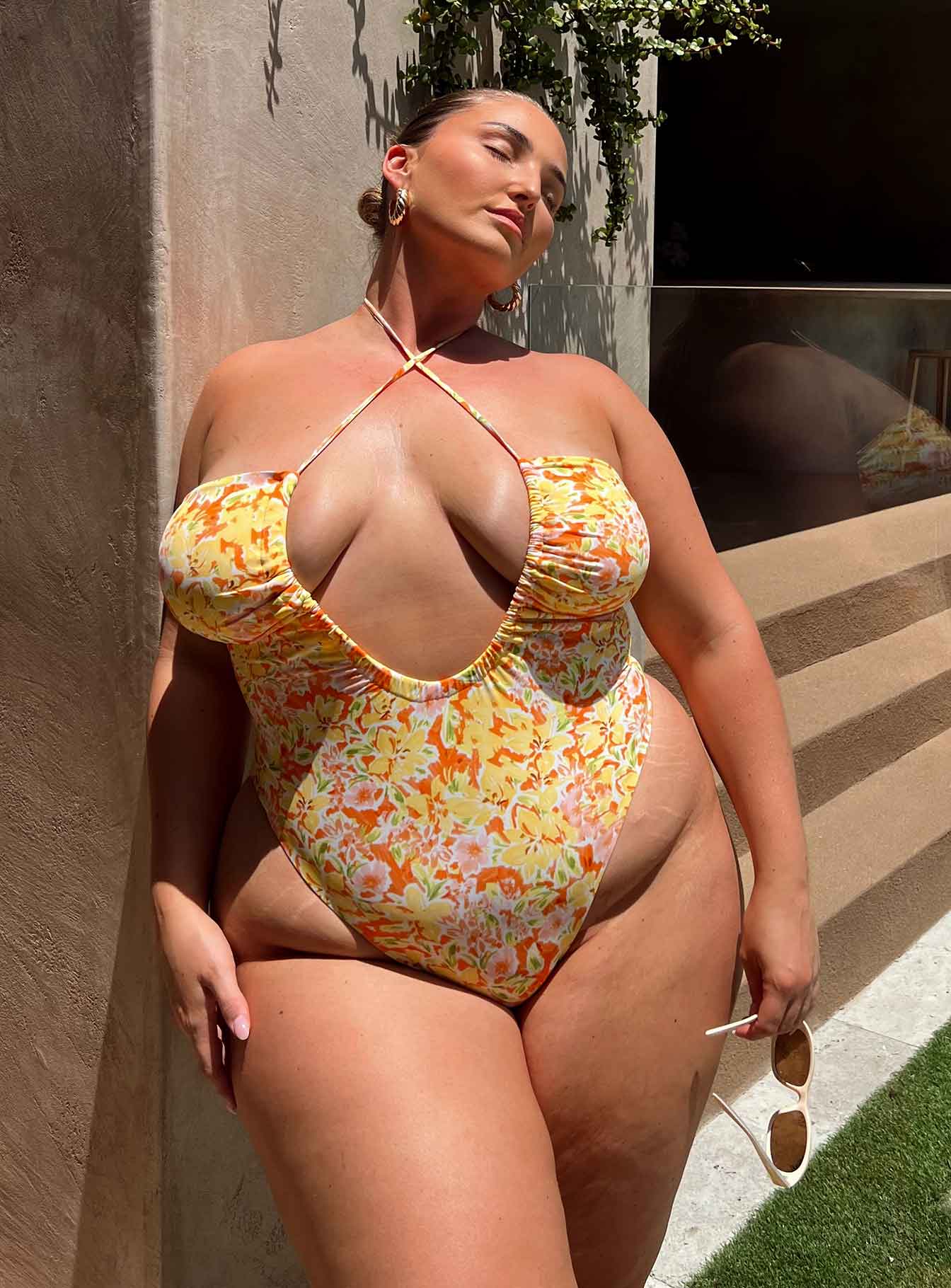 One piece Halter neck tie fastening Adjustable scooped neckline Low back High cut leg Brief style bottom Removable padding