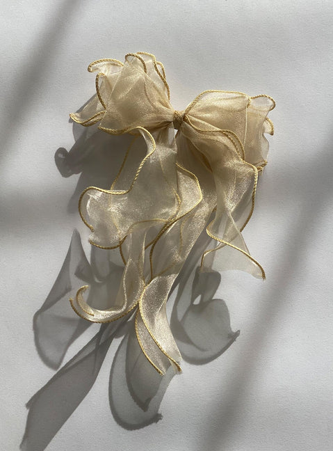 Hair bow  95% polyester 5% iron Sheer sparkly material  Silver-toned hardware  Snap clip fastening 