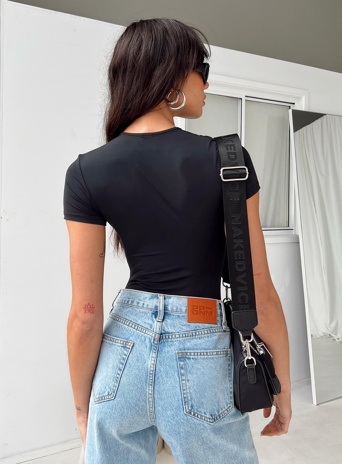 back view of model wearing Princess Polly Rover Bodysuit Black Short Sleeve 