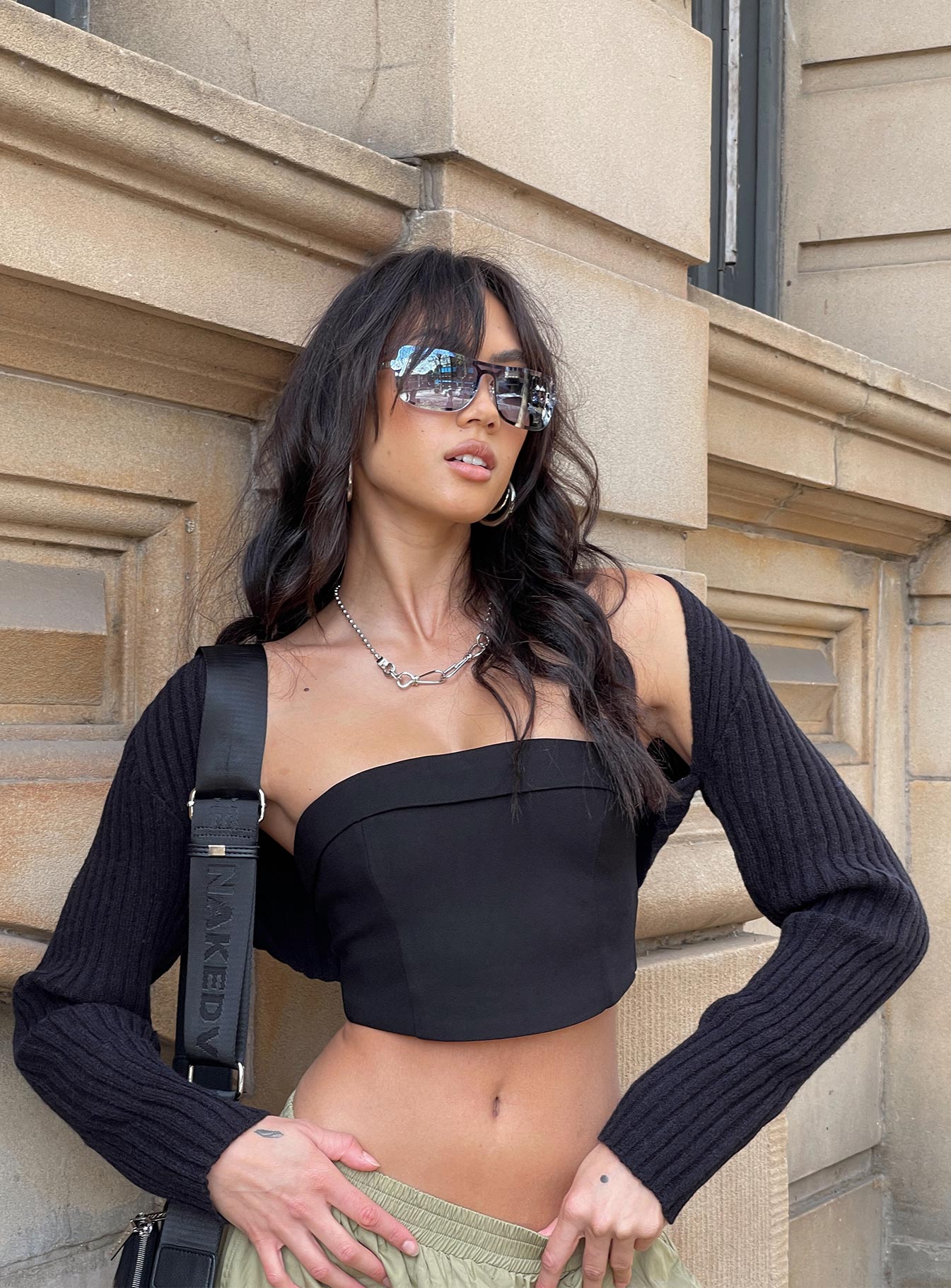 Introducing the Aytan Bolero Sweater in Black, a short jumper with cold shoulder detailing, front view of model wearing Princess Polly